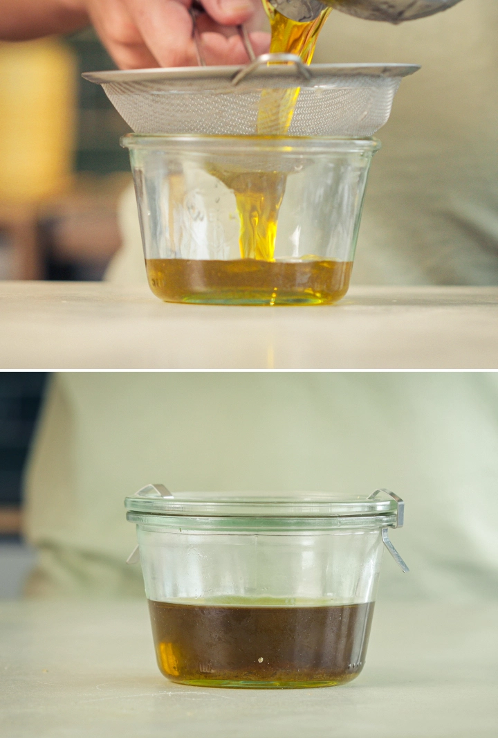 Filtrado del aceite de oliva infusionado con cannabis Aceite de oliva infusionado con cannabis filtrándose a través de un colador fino en un recipiente de cristal.